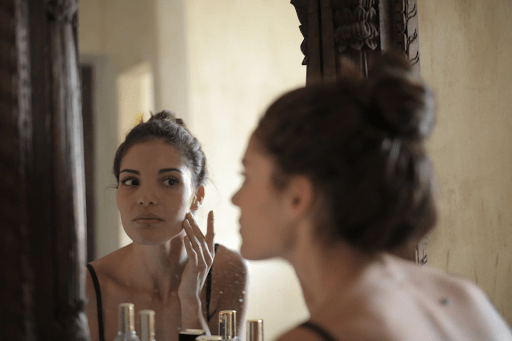 A woman wondering when she should start using anti-aging products.